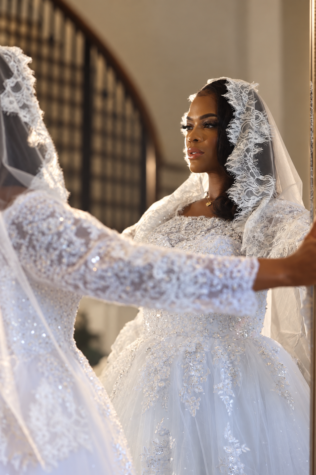 Woman facing her reflection in a bridal veil